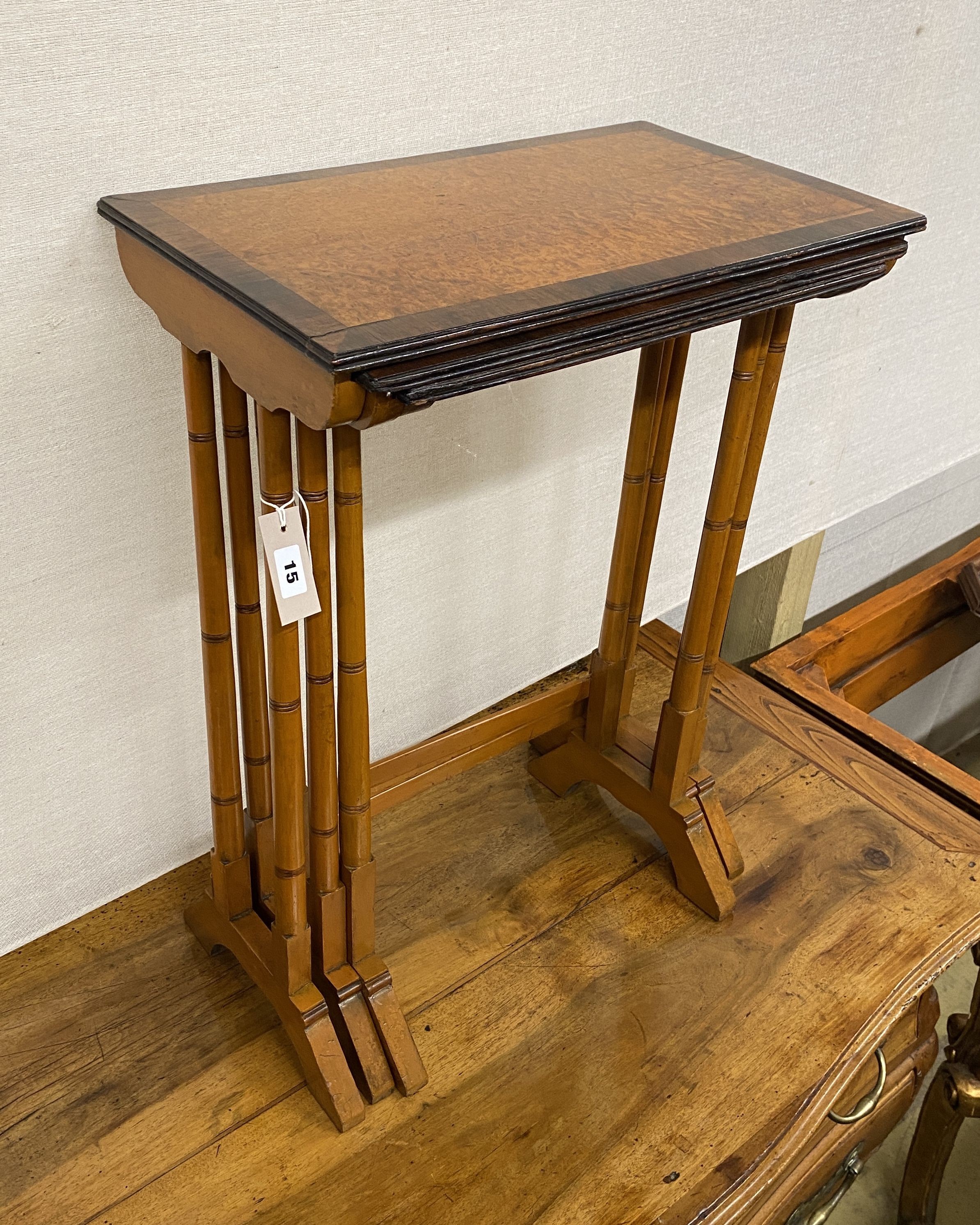 A nest of three mahogany and bird's eye maple rectangular tea tables, width 50cm, depth 30cm, height 69cm